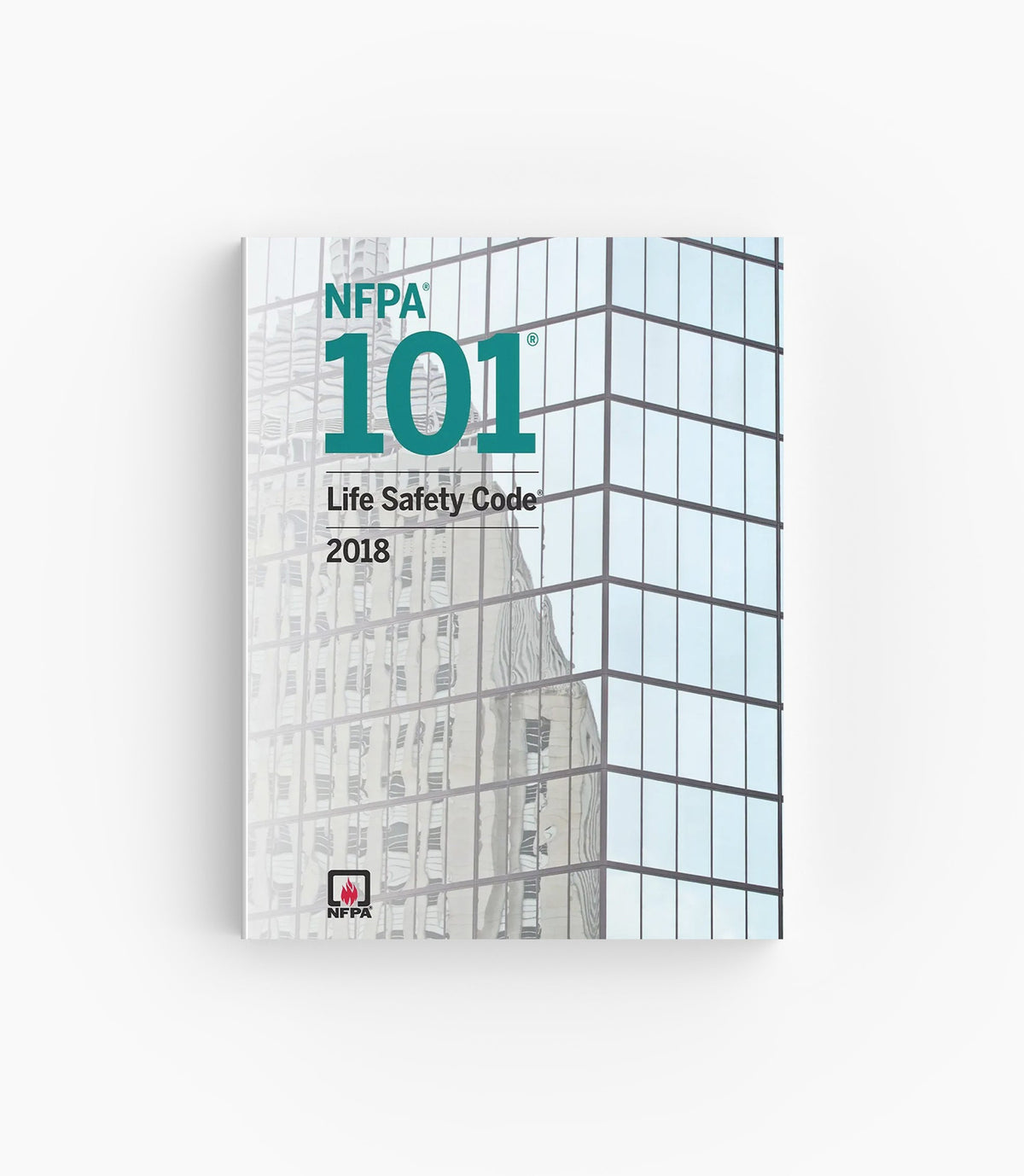 Product photo of 2018 NFPA 101 Life Safety Code, lying flat with the front cover visible.